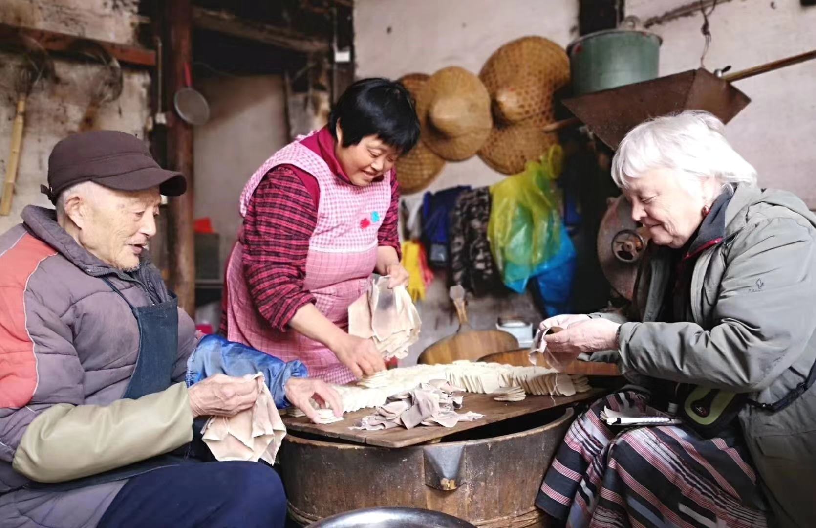 Travelers taking part in a hands-on food preparation activity