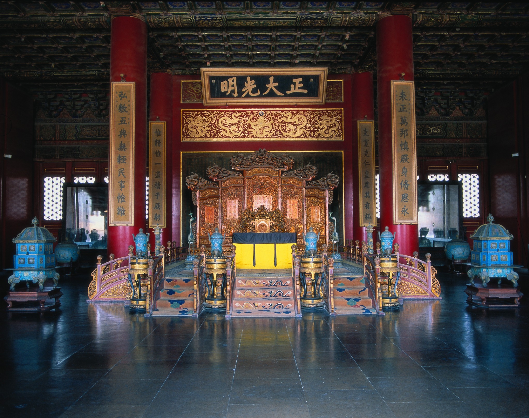 Ornate imperial throne room with red columns and gilded decorations in the Forbidden City